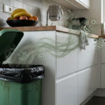Traditional kitchen trash can releasing bacteria plumes and foul odors